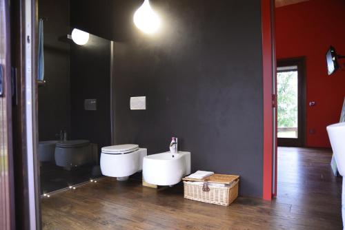 a bathroom with a white toilet and a sink at Dolce Casetta in Faenza