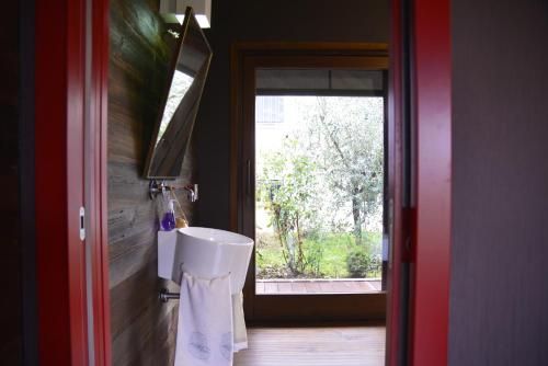 a bathroom with a toilet in a room with a window at Dolce Casetta in Faenza