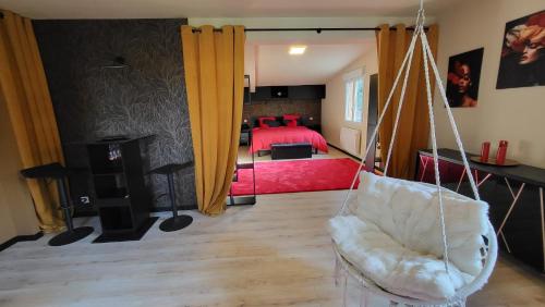 a swing in a room with a bedroom at Loveroom in Lavoux