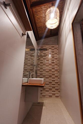 a bathroom with a sink and a staircase at Tigbaw in Mactan