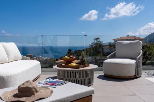 a patio with two chairs and a table with a view at villa yasmin luxury in Bali