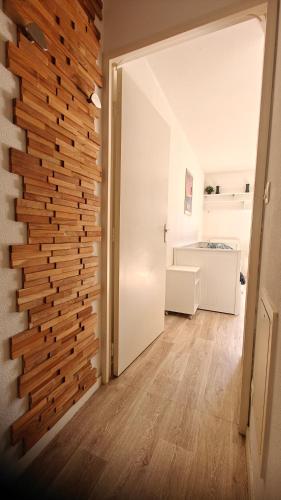 a wooden wall in a room with a hallway at CHROMA - Studio Nantes GARE SUD in Nantes