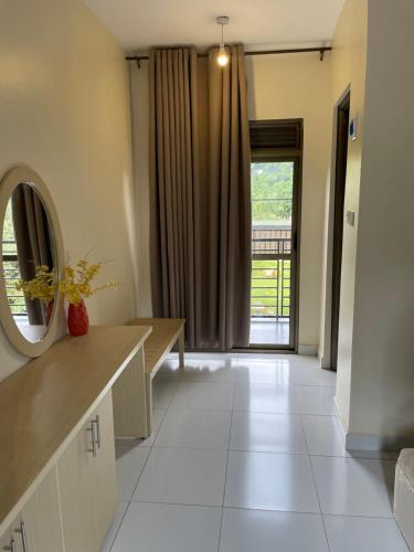 a bathroom with a mirror and a sink and a mirror at Cleopatra Gardens in Kampala