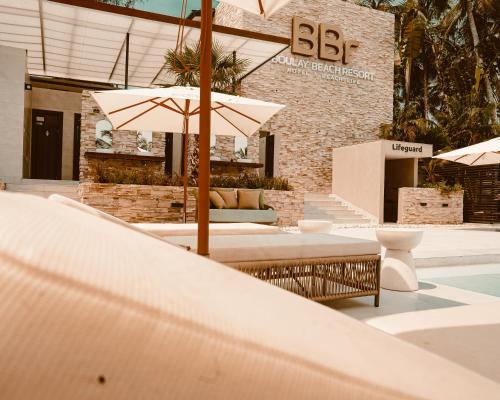 a patio with umbrellas in front of a building at BBr in Jacqueville