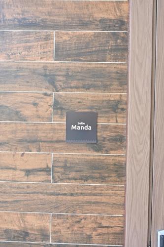 a wooden wall with a sign that reads main manda at BBr in Jacqueville