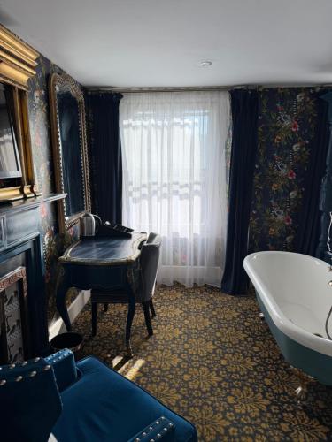 a bathroom with a tub and a mirror and a sink at Durham Central Suites in Gilesgate