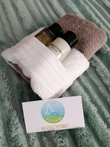 a bottle of moisturizing moisturizing moisturizing cream next to a towel at 47atKabega in Gqeberha