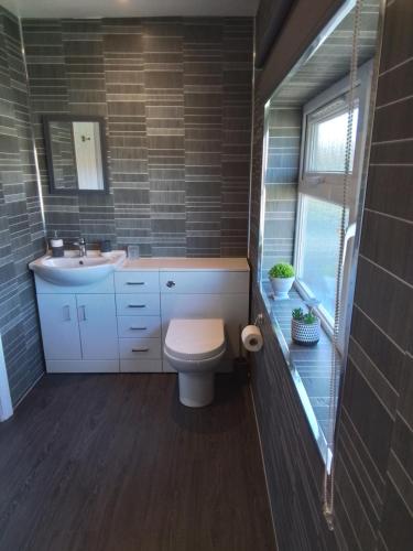 a bathroom with a toilet and a sink at Large double room with spacious ensuite in Southbourne