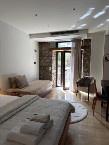 a bedroom with a bed and a living room at Olympus Stone Lodge in Litochoro