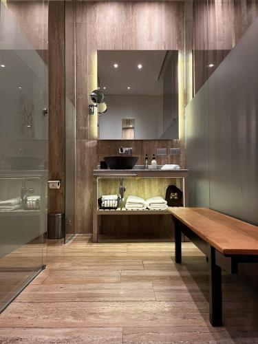 a kitchen with a wooden table and a mirror at Hotel Magnolia Santiago in Santiago