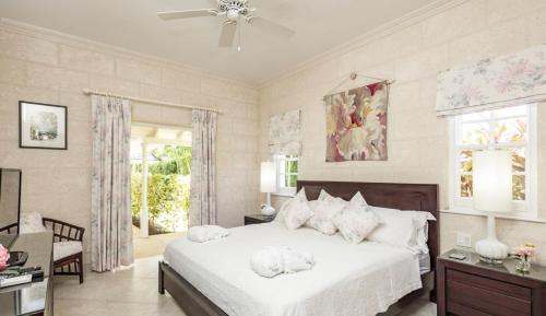 a bedroom with a large bed with white sheets and pillows at Royal Westmoreland Lonetrees - by ZenBreak in Saint James