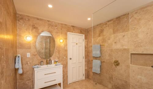 a bathroom with a sink and a mirror at Royal Westmoreland Lonetrees - by ZenBreak in Saint James