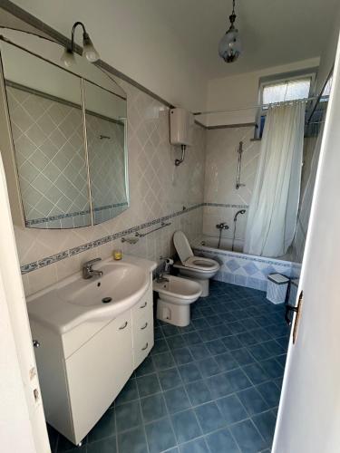 a bathroom with a sink and a toilet and a mirror at Casa Vacanze Anema & Core in Agerola