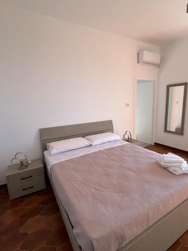 a bedroom with a large bed with a mirror at Casa Vacanze Anema & Core in Agerola
