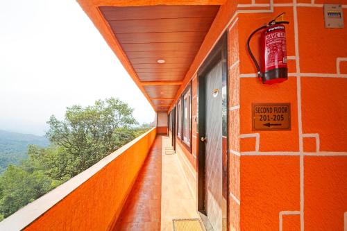 an orange building with a sign on the side of it at Hotel O Tanatan Premium in Bhopal