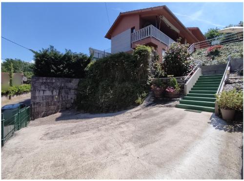 a house with stairs leading up to a driveway at Eido da Consaca in Ponteareas