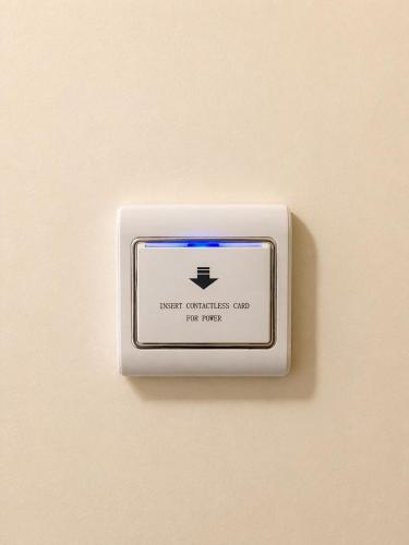 a lightswitch on a wall with a sign on it at Fuscaldo Hotel in Valledupar