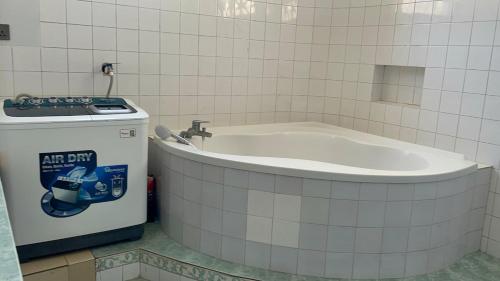 a bath tub in a bathroom next to a water fountain at Diani Hideaway Beach Villa, private pool, air conditioning and WiFi in Galu