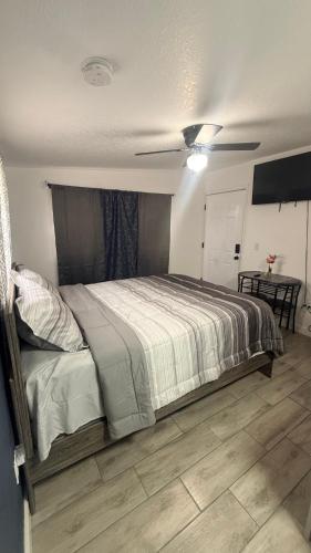 a bedroom with a bed with a ceiling fan at DC lodging LLC in Tampa
