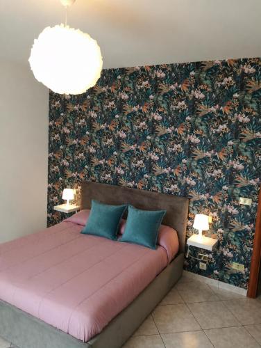 a bedroom with a bed with a floral wallpaper at Domus Sofia in Ripa Teatina
