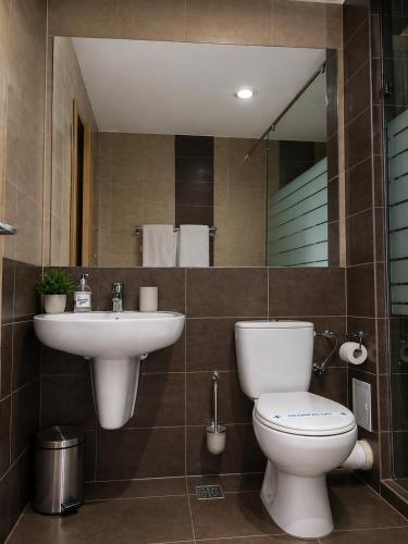 a bathroom with a sink and a toilet and a mirror at HF - Mamaia Nord in Mamaia Sat/Năvodari