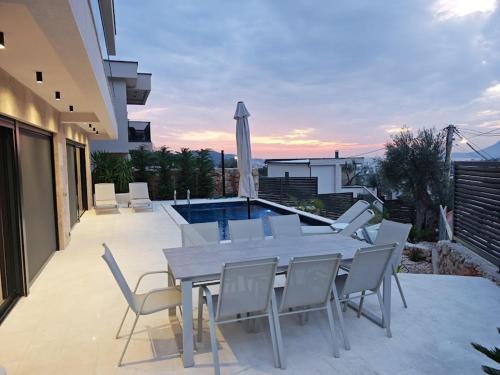 a patio with a table and chairs and a pool at Villa Bartula in Bar