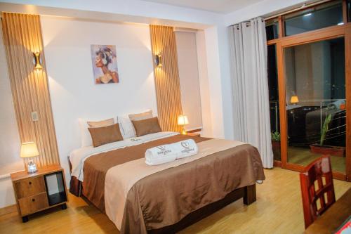 a hotel room with a bed and a large window at HOTEL TERRANOVA Abancay in Abancay