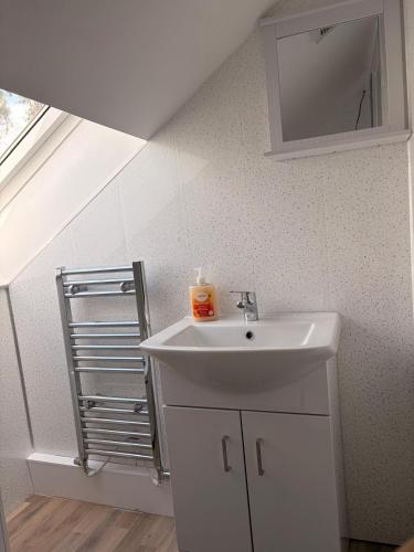 a bathroom with a sink and a mirror at Easy living stays Burton on Trent in Burton upon Trent