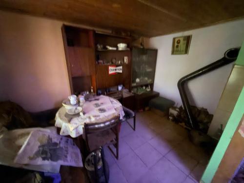 a living room with a table in a room at Kazanlak SHELTER HOUSE ACCOMODATION 1 Room 1 Bed, No Water, WC is Outhouse, Dirt Road, Dog in the Garden, Genius Points Welcome! Къща за Подслон в Казанлък, Без Вода! in Kazanlŭk