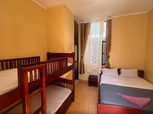 a bedroom with two bunk beds and a window at Zebra guesthouse Hawassa in Āwasa