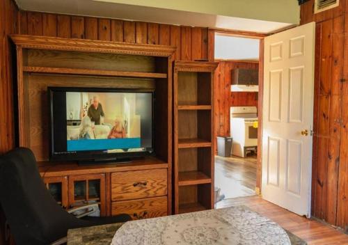 a living room with a flat screen tv in a entertainment center at GpL 3321 Downtown Fort Myers Retreat in Fort Myers