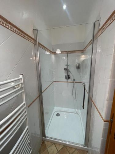 a shower with a glass door in a bathroom at Chambre d'hôtes "La Bastide des Eucalyptus" in Antibes