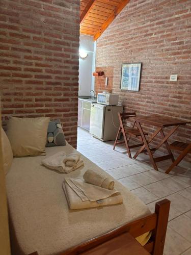 a room with a bed and a brick wall at Complejo Aldea Champaqui in Villa General Belgrano