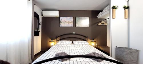 a bedroom with a bed with two pillows on it at West Garden At Aigio By Greece Apartments in Aigio