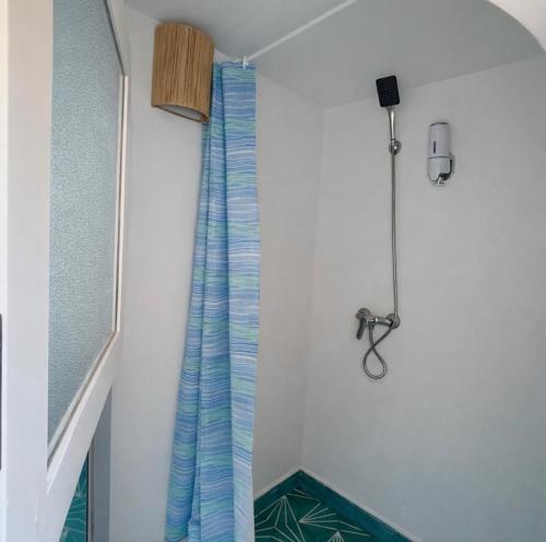 a shower curtain in a room with a microphone at Lodgegarden in Aït Bounnit