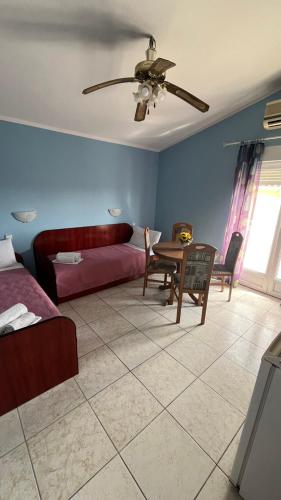 a living room with a bed and a table at Konak Vukojević in Šušanj