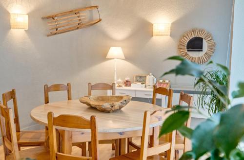 a dining room table and chairs with a bowl on it at Hotel Anglada in Vielha