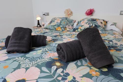 a bed with two rolls of yarn on it at Puerta de Arcos in Arcos de la Frontera