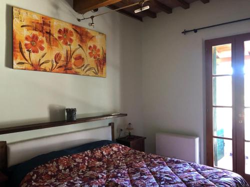 a bedroom with a bed and a painting on the wall at Casa Varna in Gambassi Terme
