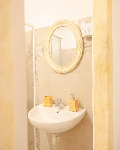 a bathroom with a sink and a mirror at Agriturismo Alveare in Finale Ligure