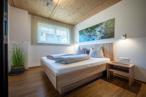 a bedroom with a large bed in a room at Alpenapart Singer - contactless check-in in Reutte