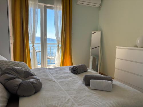 a bedroom with a bed with towels on it at Apartments New Charming in Senj