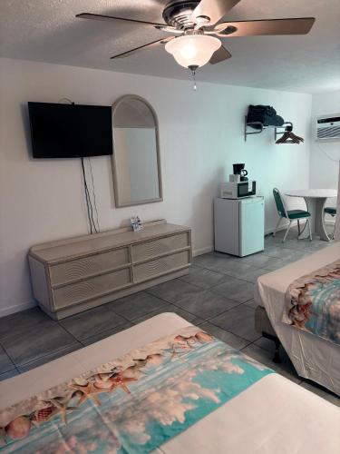 a hotel room with two beds and a flat screen tv at Apollo Motel in Wildwood Crest