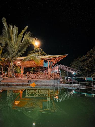 a resort with a pool of water at night at La Chorrera ecohotel in Cocorná