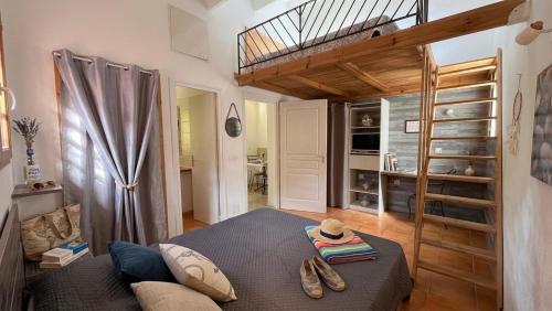 a bedroom with a loft bed with a bunk bed at Le Maquis Plage Corse in Poggio-Mezzana