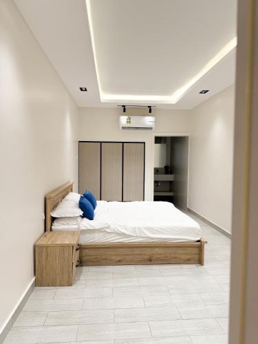 a bedroom with a bed in a white room at Lava & Luna chalets in Sohar