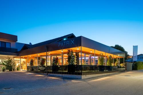 a large building with christmas trees in front of it at Patrix Hotel, Restaurant, Bar in Frankenburg