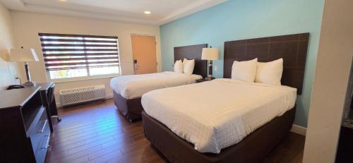 a hotel room with two beds and a window at Curtis Inn & Suites in Hollywood