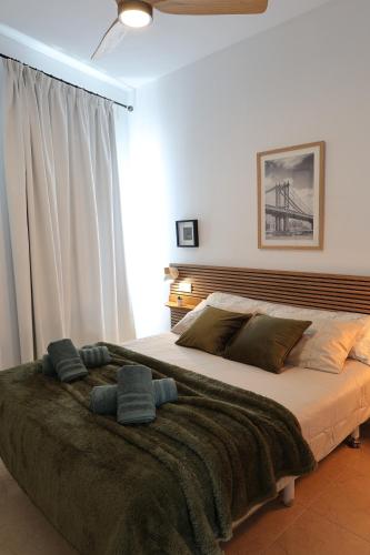 a bedroom with a large bed with a blanket at Paseo Imperial in Arcos de la Frontera
