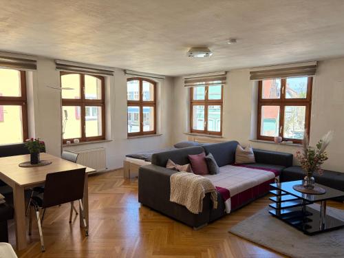 a living room with a couch and a table at Stilvolles Altstadt-Apartment in Bestlage in Dinkelsbühl